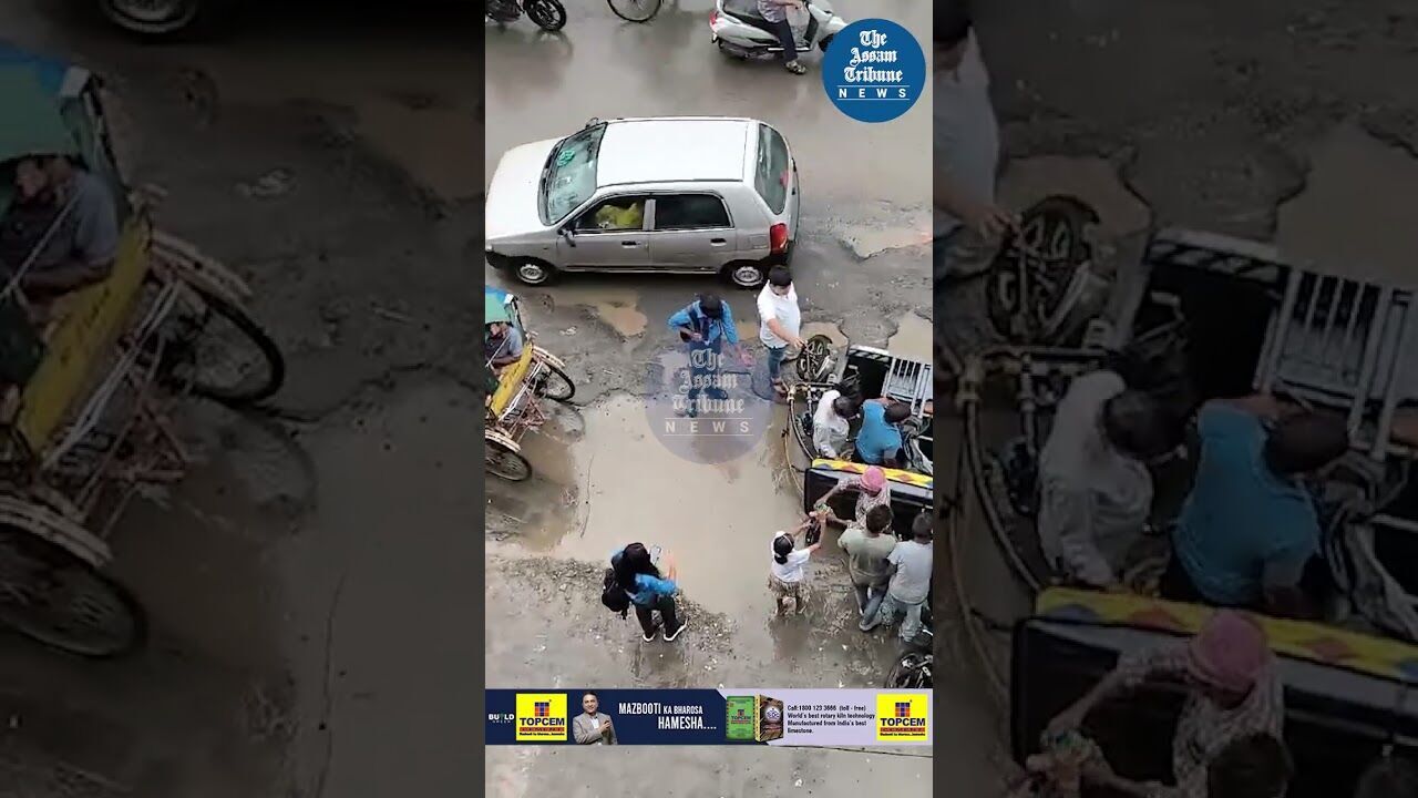 Silchar: E Rickshaw topples in pothole-filled road