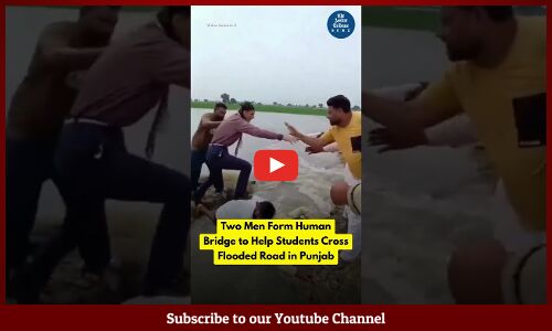 Two Men Form Human Bridge to Help Students Cross Flooded Road in Punjab