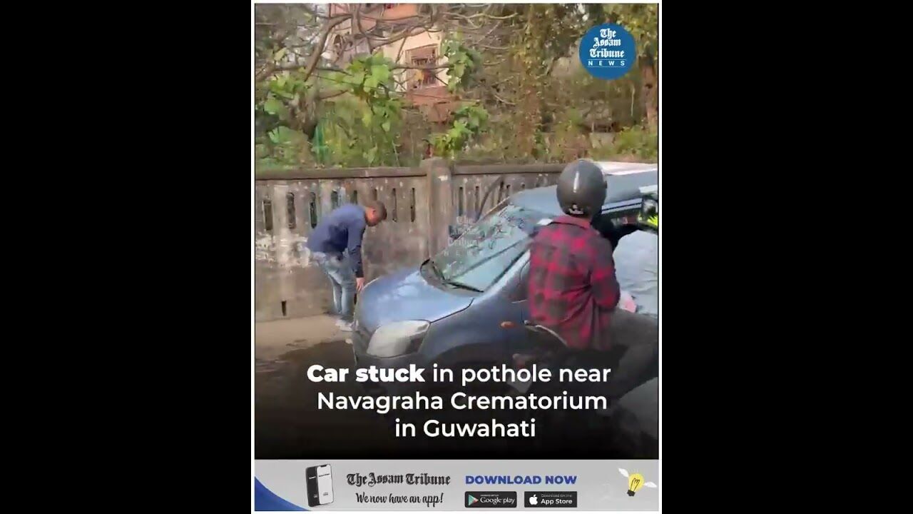 Car stuck in pothole near Navagraha Crematorium in Guwahati